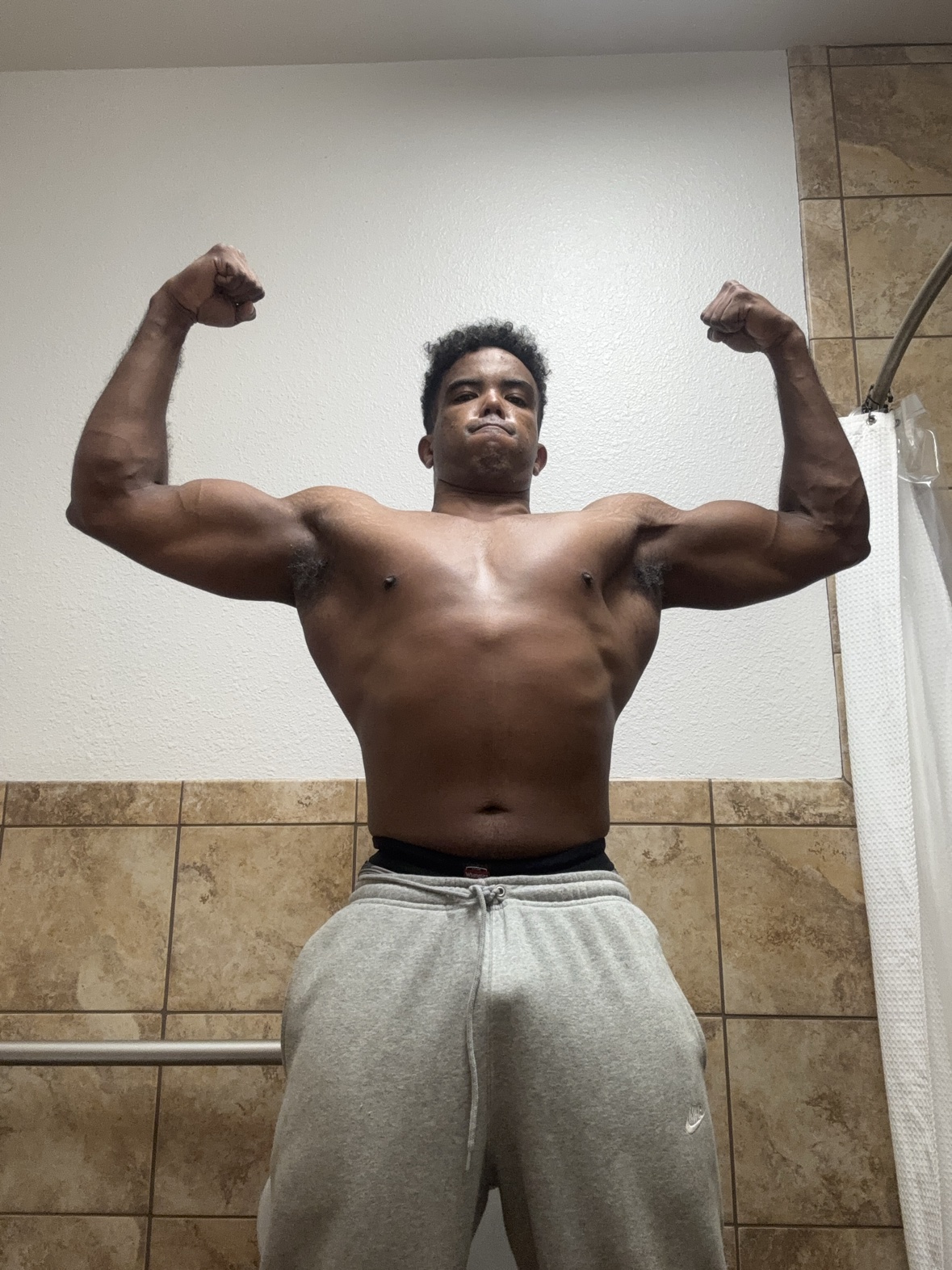 Athlete side pose showing arm and shoulder development