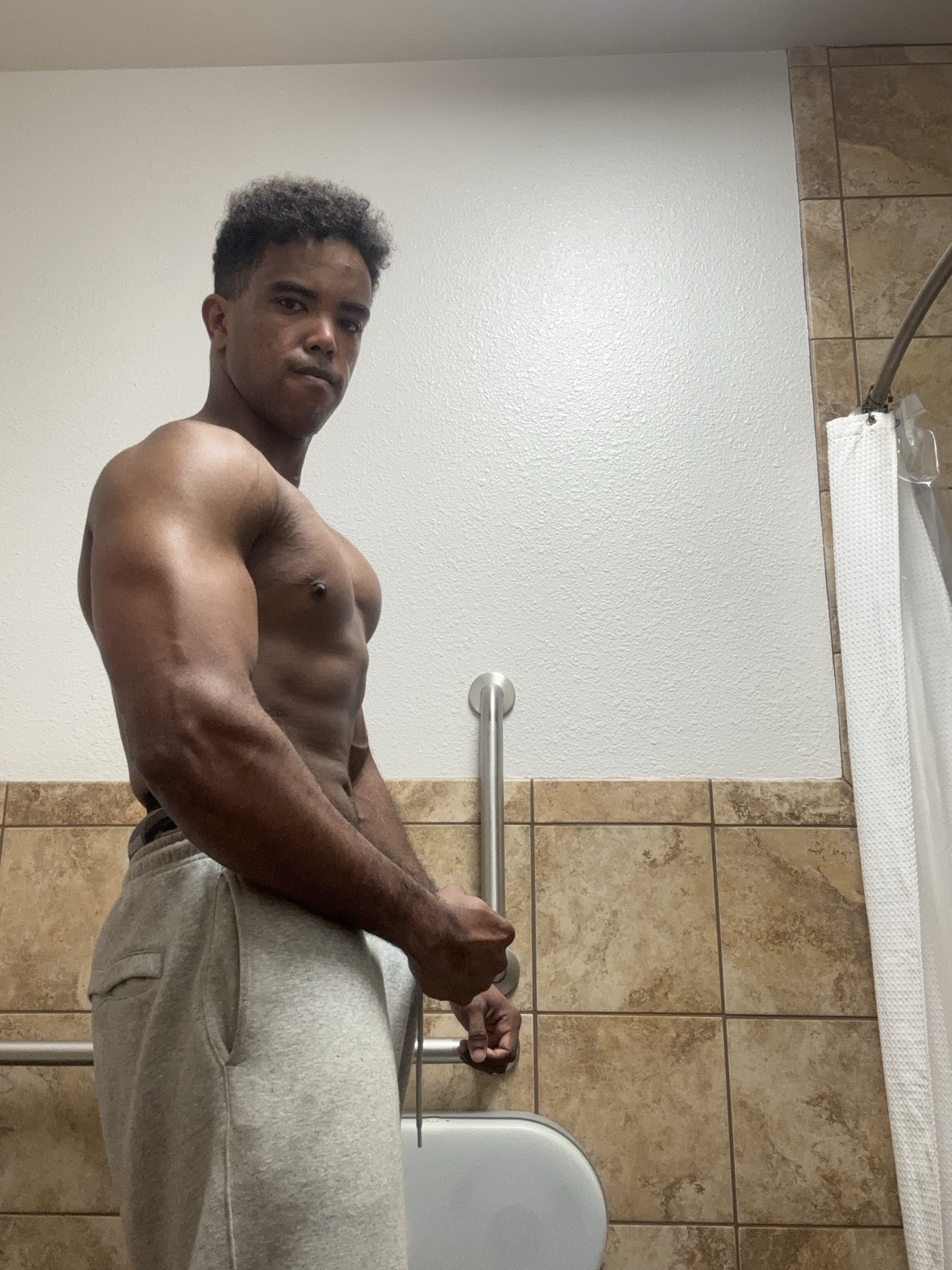Athlete side pose showing chest and arm development